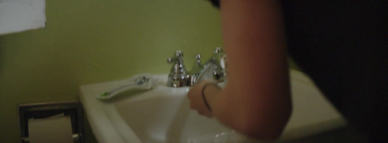 A woman brushes her teeth