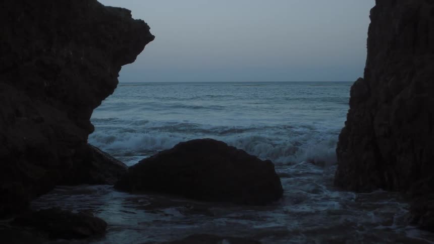 Ocean waves crash into rocks