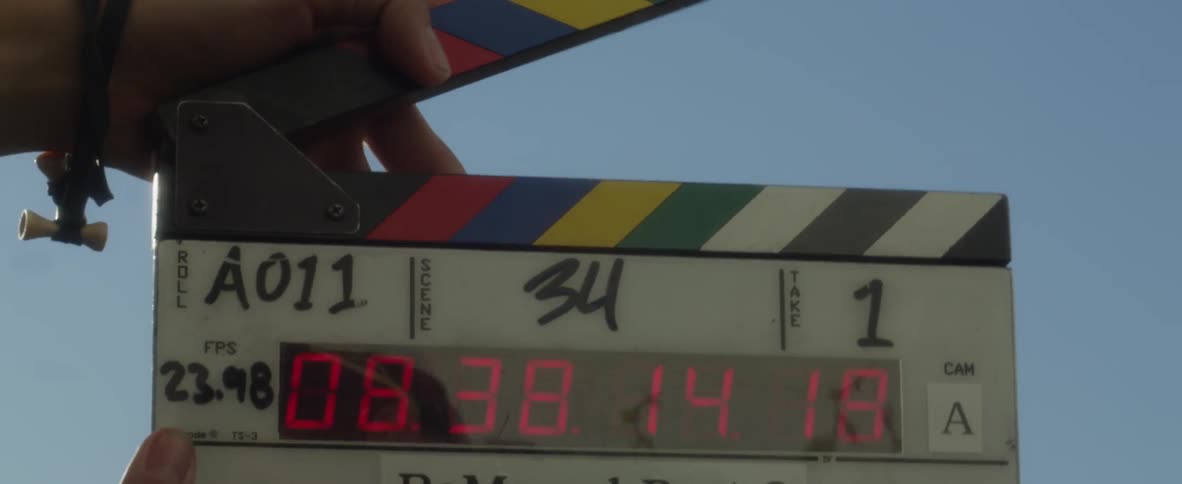 A movie clapboard starts a scene