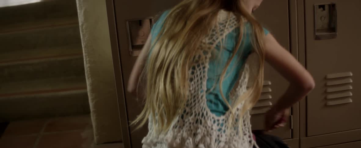 A girl opens her school locker and backpack