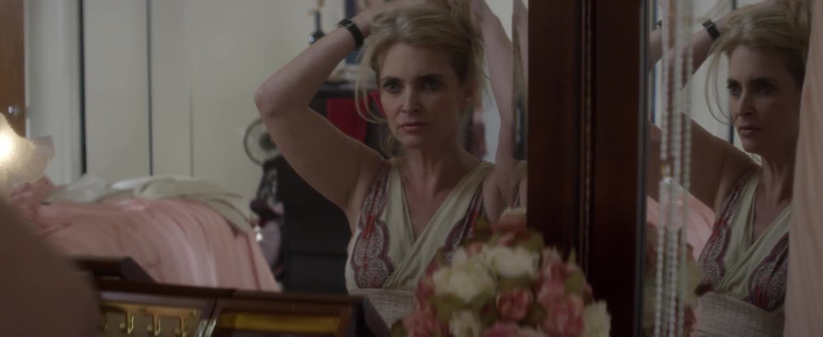 A woman is fixing her hair