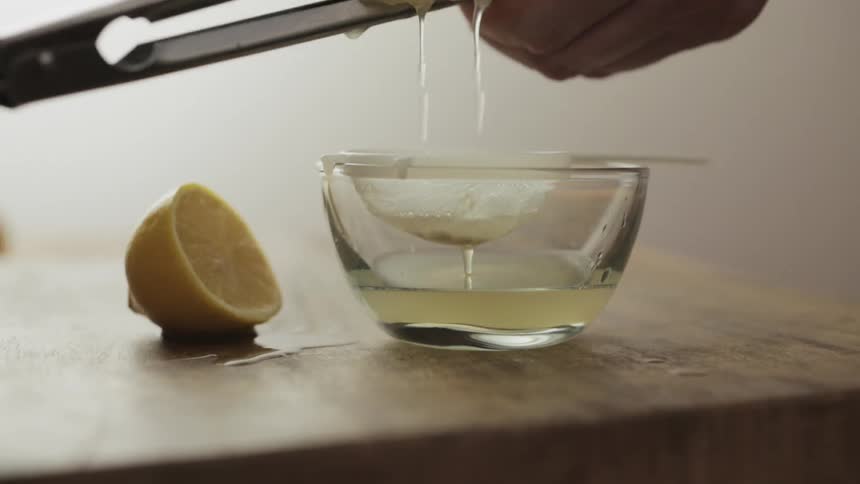 A lemon is being squeezed