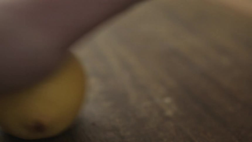 Lemon being rolled on the table