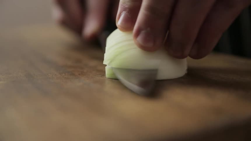 Half an onion being diced
