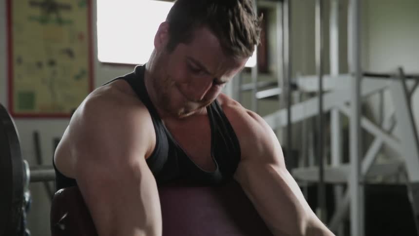 A man lifts weights at the gym