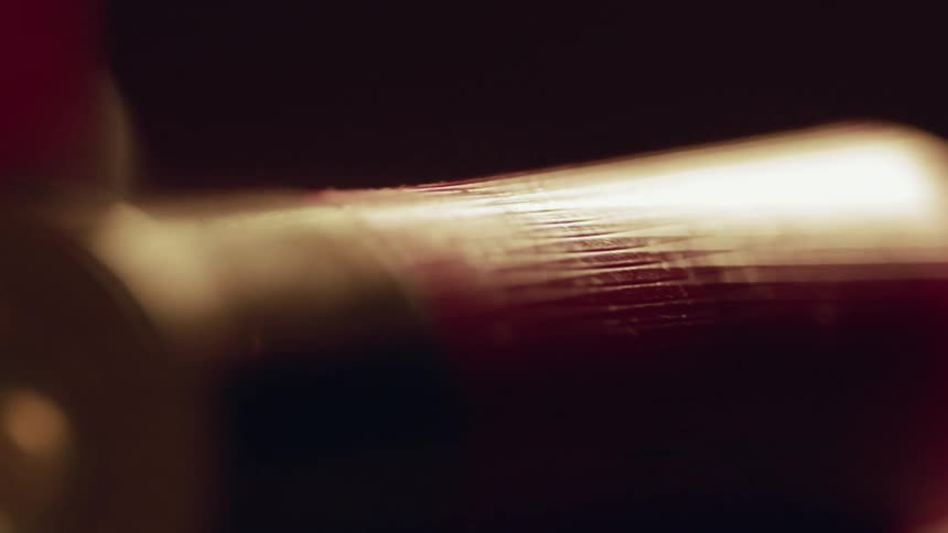 The shotgun shell sits on the dark table