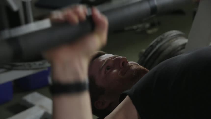 A man is bench pressing