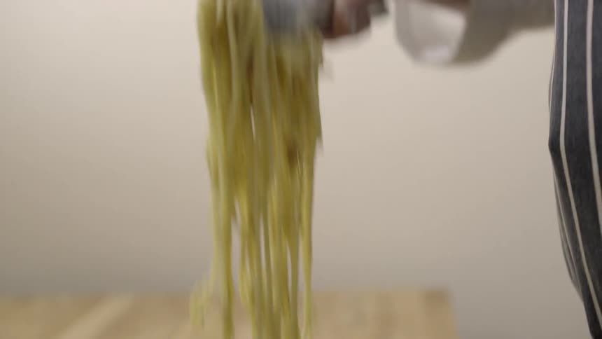 Close up of noodles being taken out of a pan