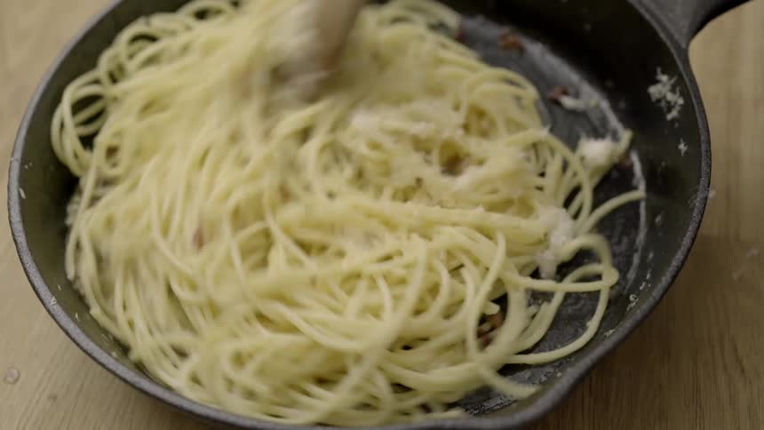 Person stirring some pasta