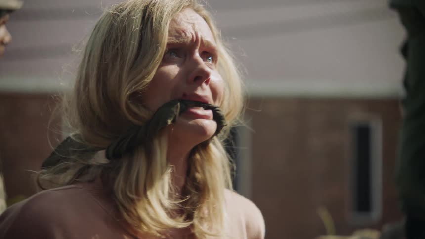 A prisoner cries with her mouth gagged