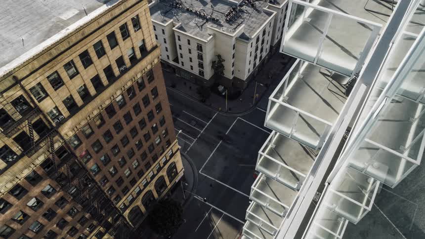 Cars drive on a busy city street