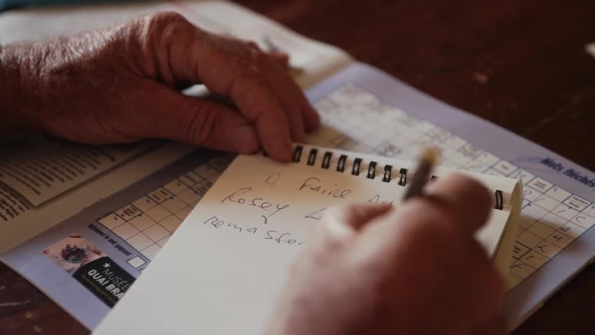 A person is writing notes in a pad