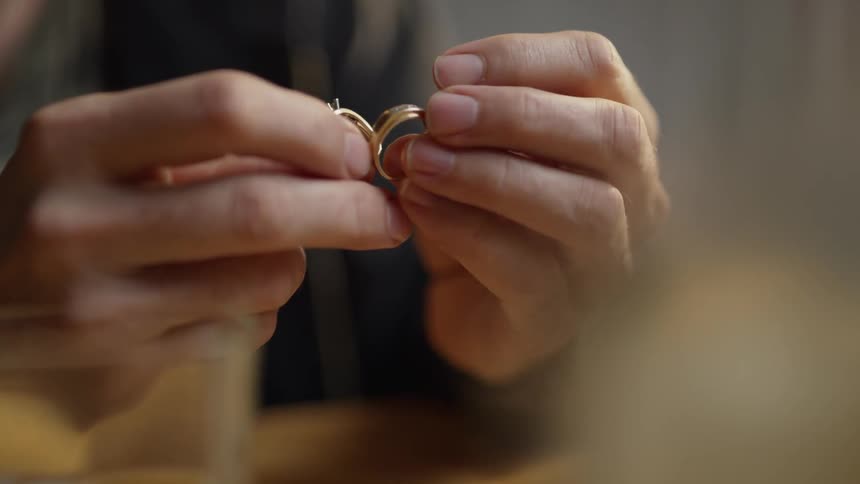 Man holds two wedding rings