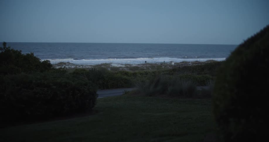 The small waves crash against the shore ahead