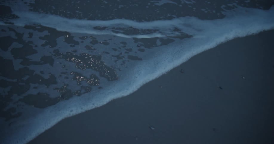 Ocean water flows over smooth sand