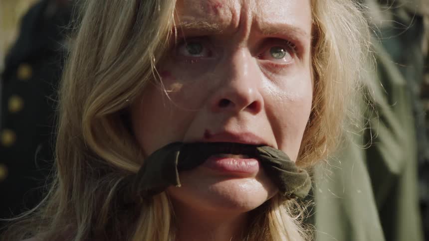 A woman is gagged and surrounded by soldiers