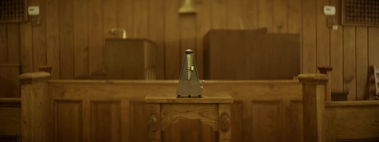 A metronome ticks in a wood room