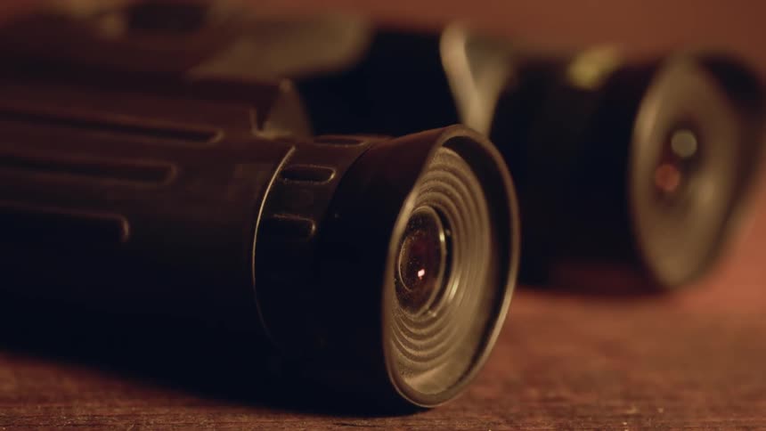 Binoculars on a wooden table