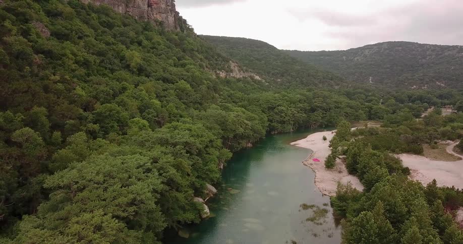 River flowing through tree covered hills