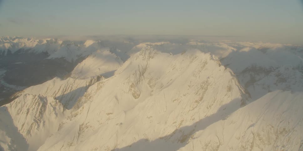 Sun shining on snow covered mountains