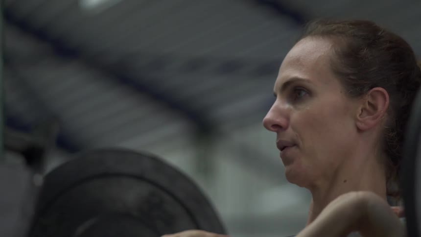 A woman is lifting weights