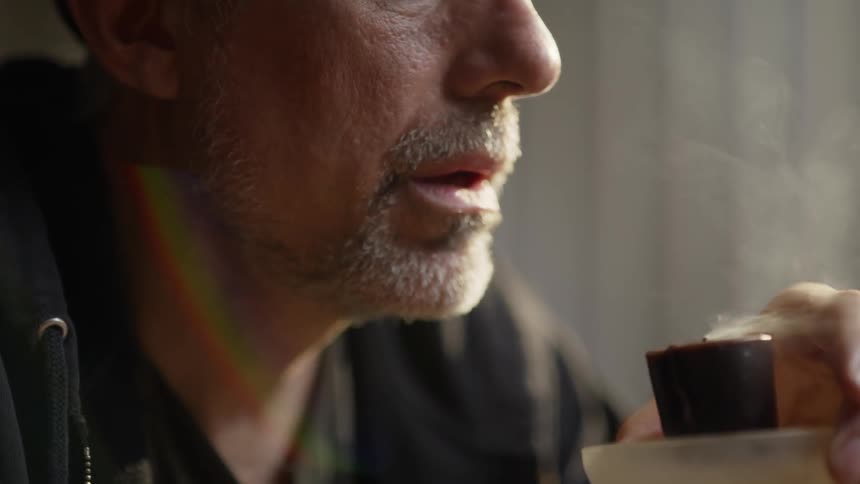 A man blows out a candle