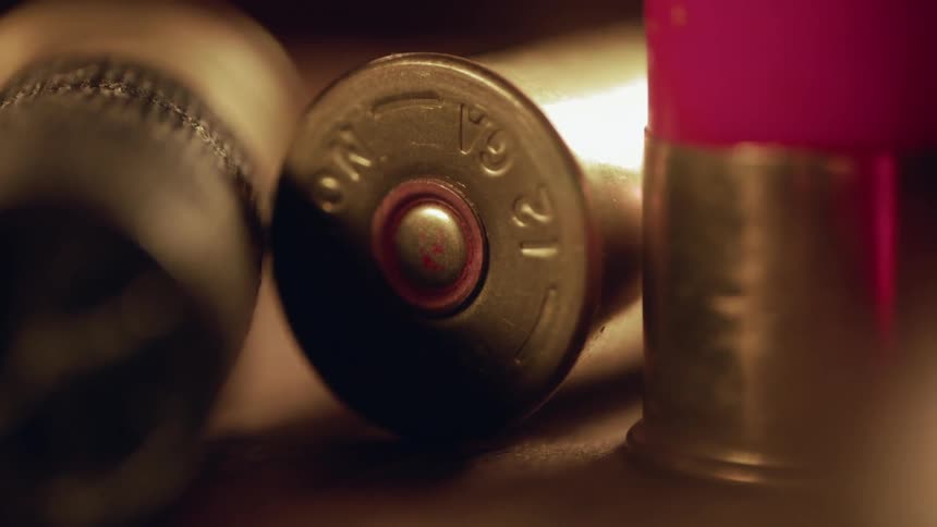 The table is covered with shotgun shells