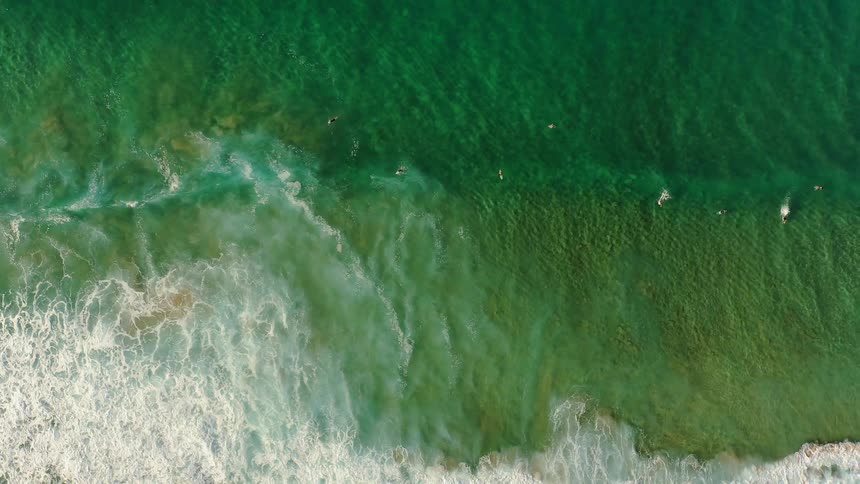 The small waves crash against the shore