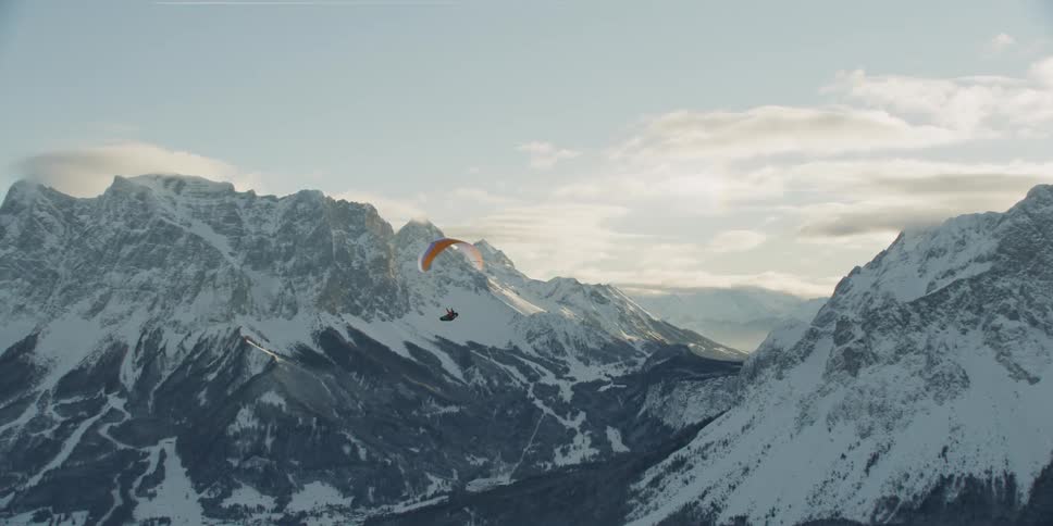 Sun shines down over snowy mountains