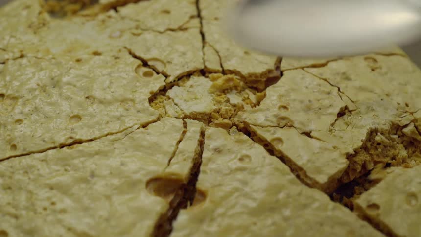 A spoon cracks hard cornbread