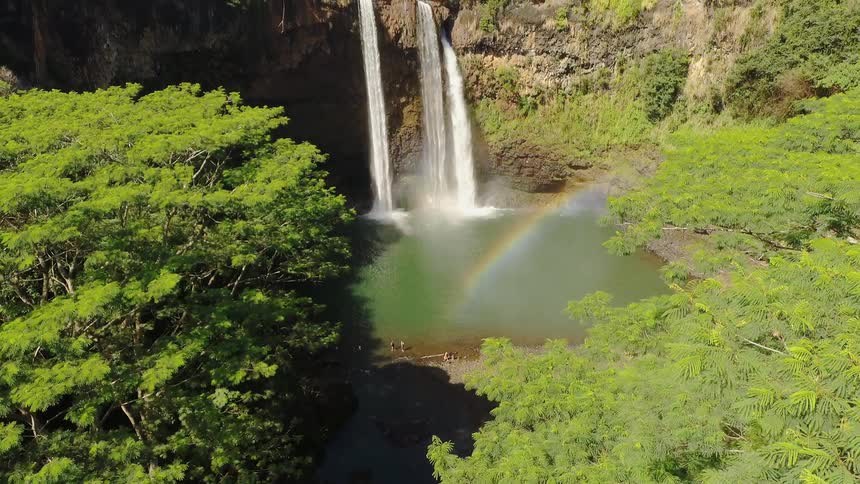 The waterfall is creating a small rainbow