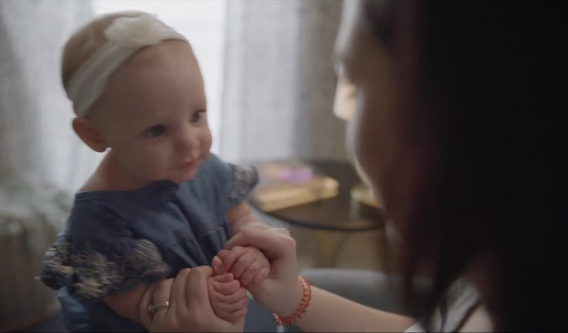 Woman playing with a baby girl