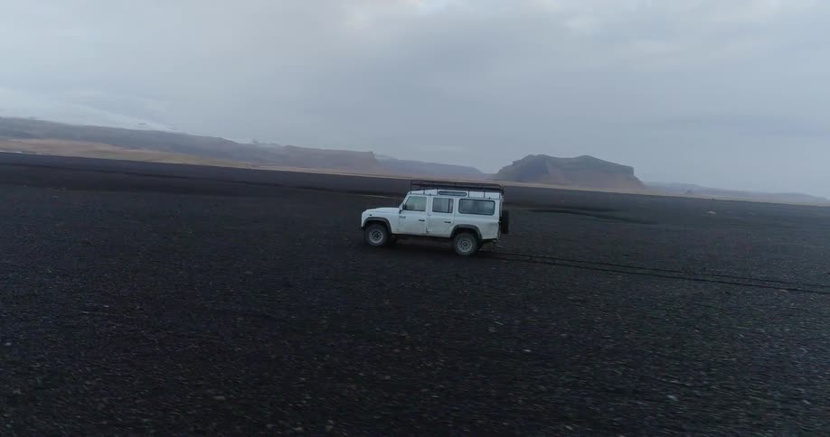 A vehicle is driving over the long field