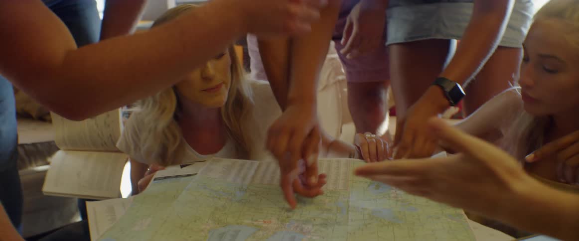 People frantically point at a map