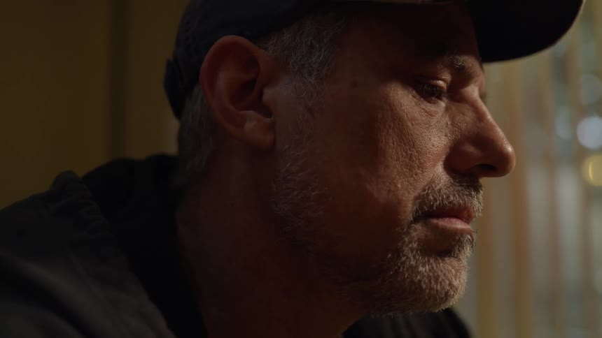Depressed looking man closes his eyes