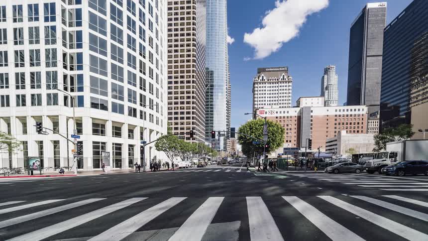 Traffic and people passing along an urban intersection