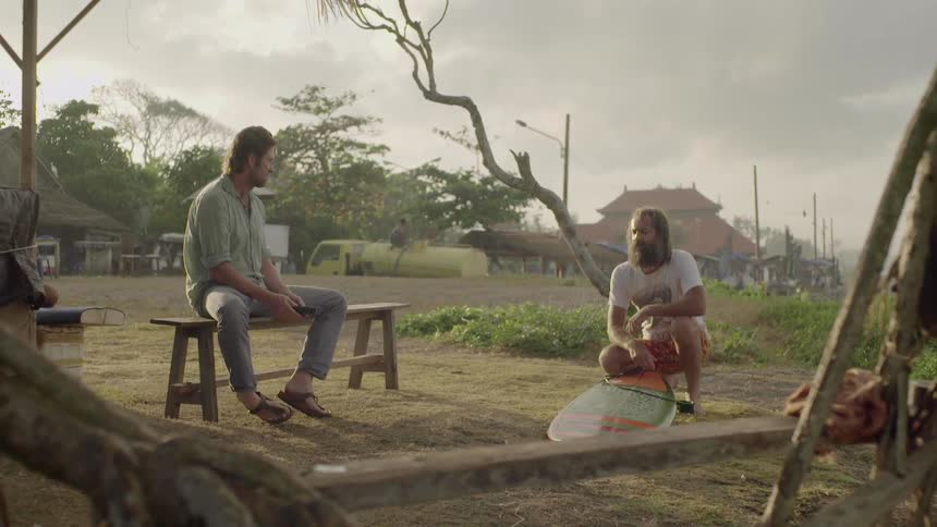 Two men talk outside on a cloudy day