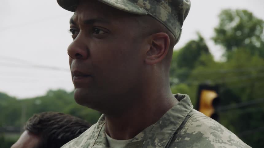 A man in military uniform yells out an order