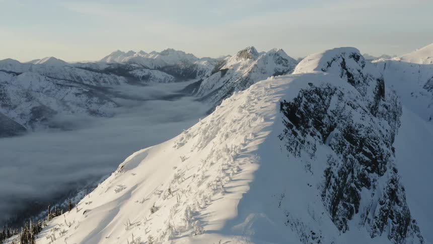 Sun shines down over snowy mountains