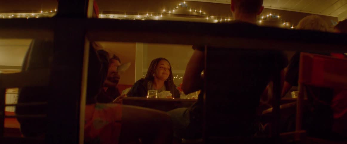 A group of people play cards together at a table