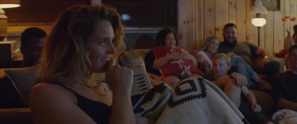 People sit watching something and laughing