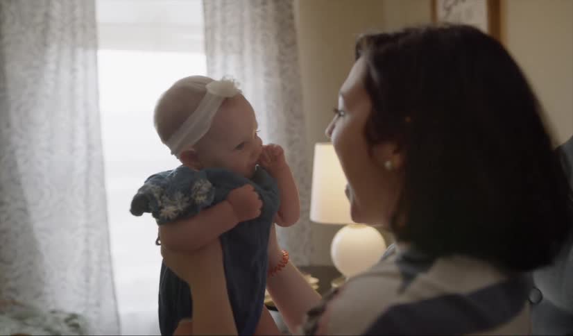 A woman tosses a baby up and down