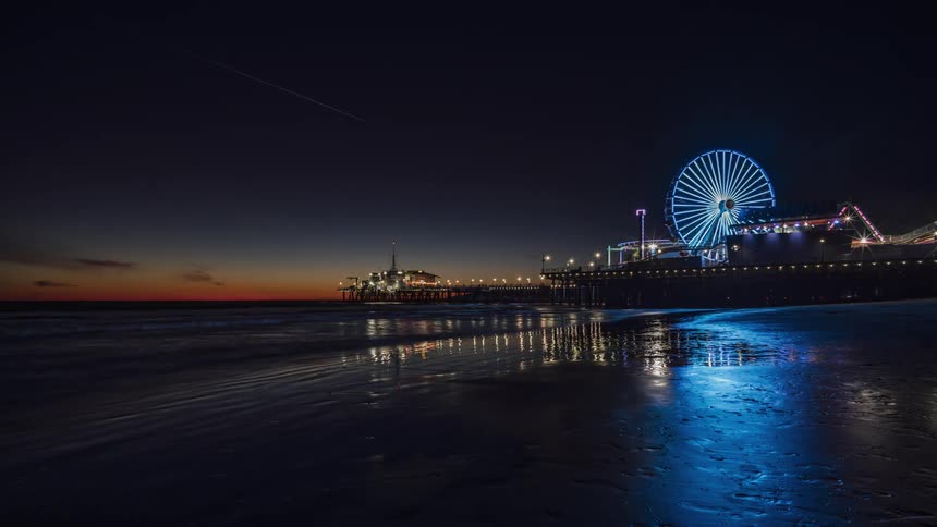 Ferris wheel near the water at night