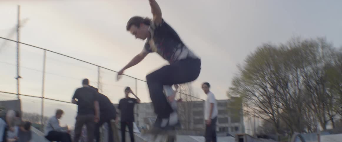 Young man skateboards over a curb and falls