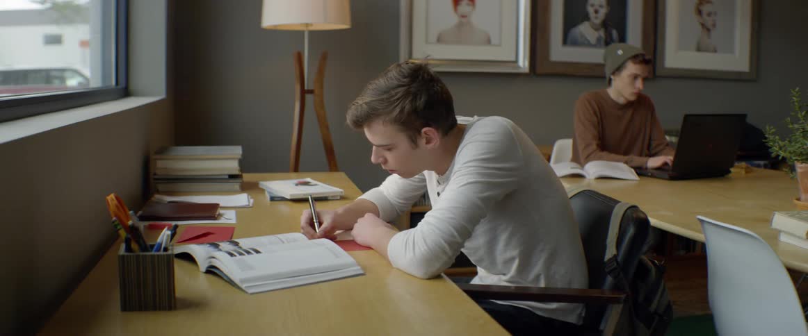 Man writes at a desk