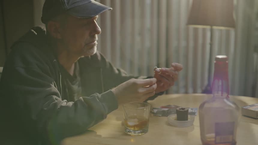 Man sitting at a table looking at rings