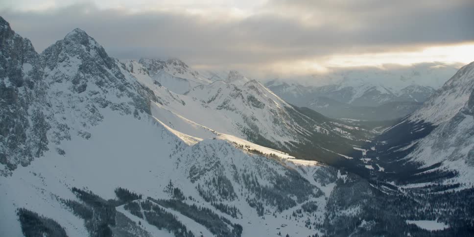Snow covered mountains under a cloudy sky