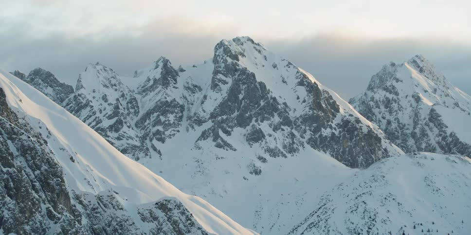 Sun shines down over snowy mountains