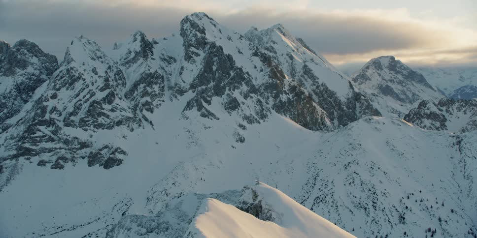 Sun shines down over snowy mountains