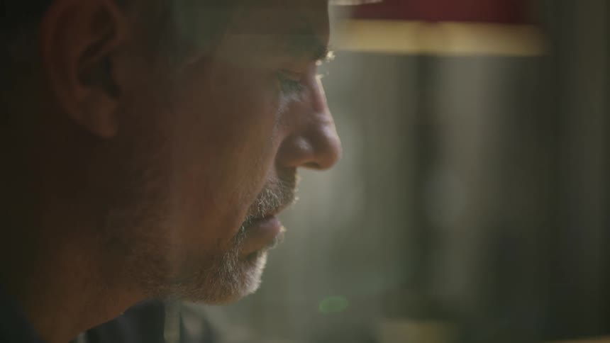Depressed looking man looks down